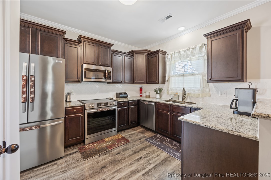 911 Townsend Road Raeford, NC 28376 - Photo 13 of 46 a kitchen with granite countertop a refrigerator stove and sink