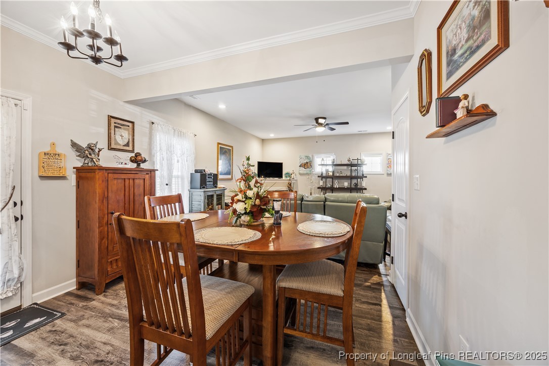 911 Townsend Road Raeford, NC 28376 - Photo 15 of 46 a view of a dining room with furniture and a chandelier