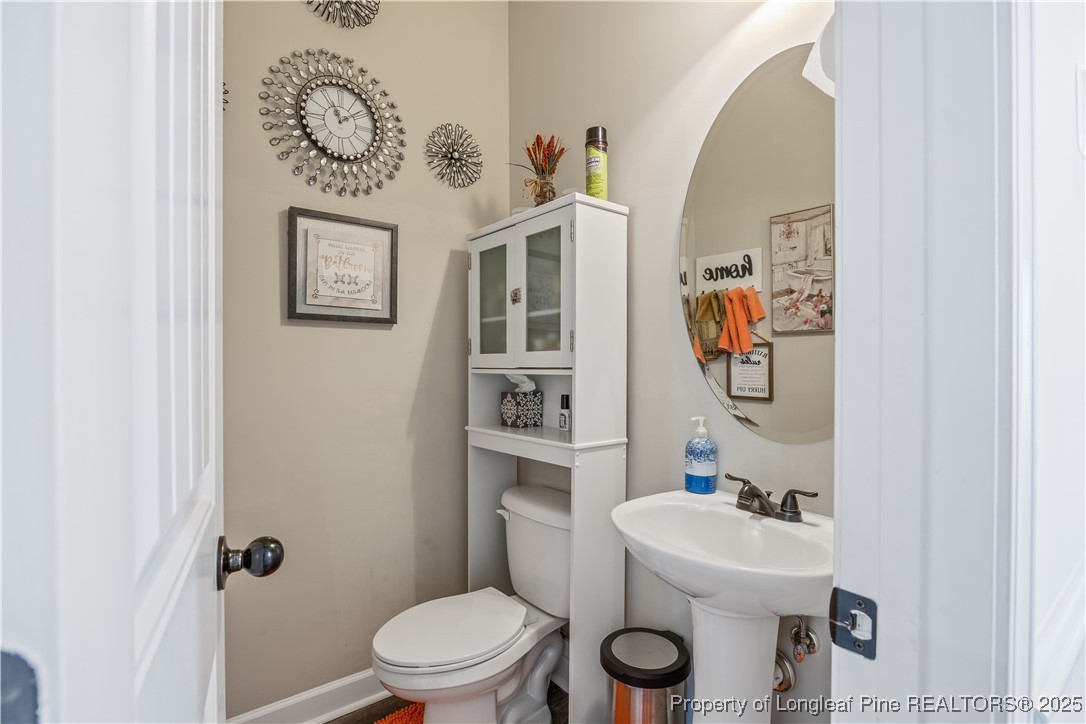 911 Townsend Road Raeford, NC 28376 - Photo 21 of 46 a bathroom with a toilet sink and mirror