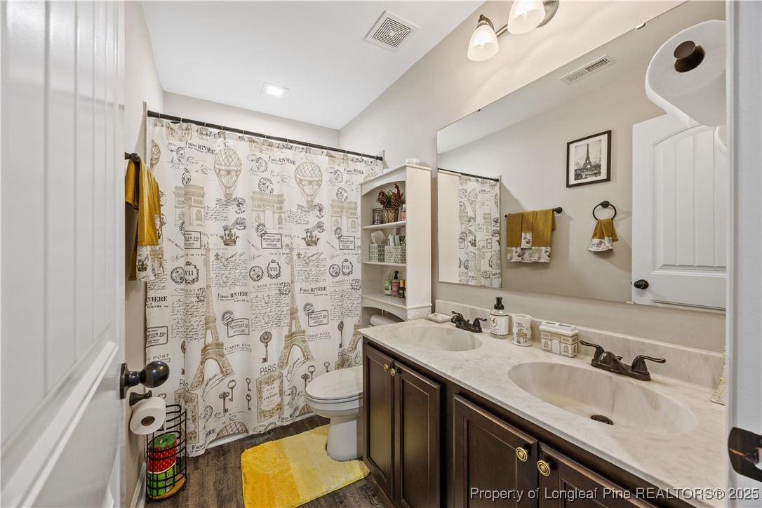 911 Townsend Road Raeford, NC 28376 - Photo 25 of 46 a bathroom with a double vanity sink mirror and shower