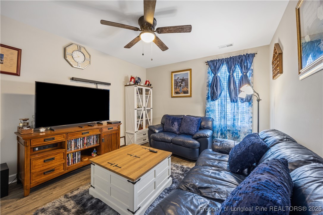 911 Townsend Road Raeford, NC 28376 - Photo 27 of 46 a living room with furniture and a flat screen tv