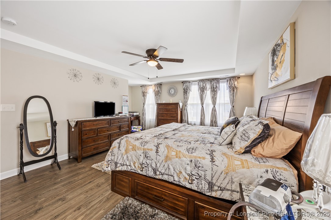 911 Townsend Road Raeford, NC 28376 - Photo 31 of 46 a bedroom with a bed and a large window with wooden floor