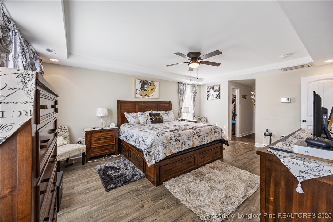 911 Townsend Road Raeford, NC 28376 - Photo 32 of 46 a bedroom with a bed a dresser with wooden floor