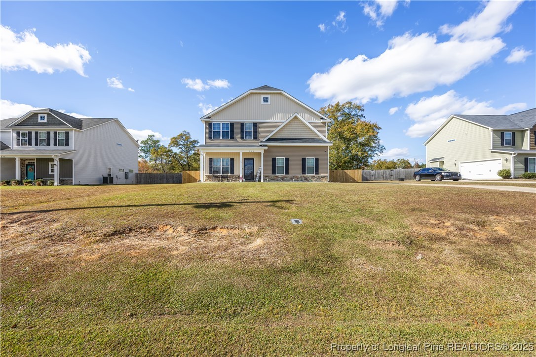 911 Townsend Road Raeford, NC 28376 - Photo 4 of 46 a view of a big house with a big yard and large trees