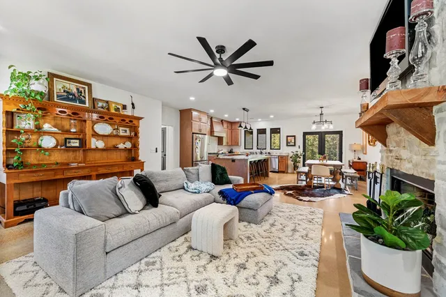 a living room with furniture a fireplace and a flat screen tv