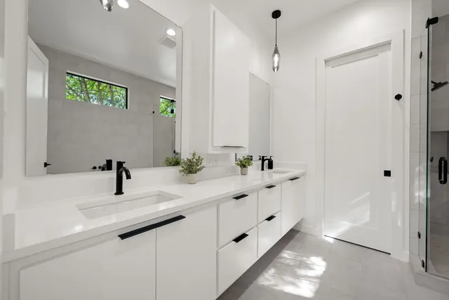 a bathroom with a double vanity sink and a mirror