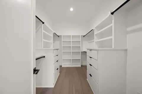 a view of walk in closet with empty racks