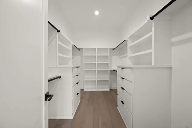 a view of walk in closet with empty racks