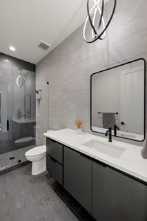 a bathroom with a double vanity sink mirror and toilet