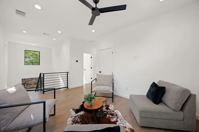 a living room with furniture and wooden floor