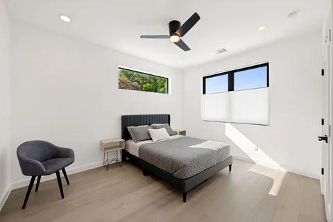 a bedroom with a bed and a chair