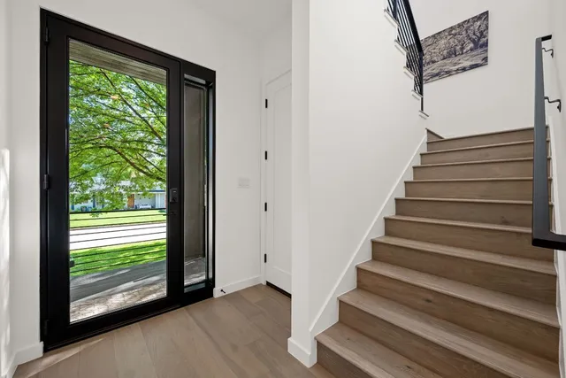 a view of entryway with wooden floor and front door