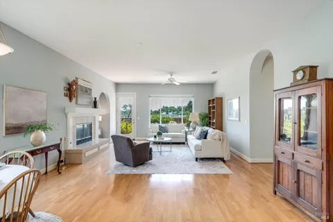 a living room with fireplace furniture and a wooden floor