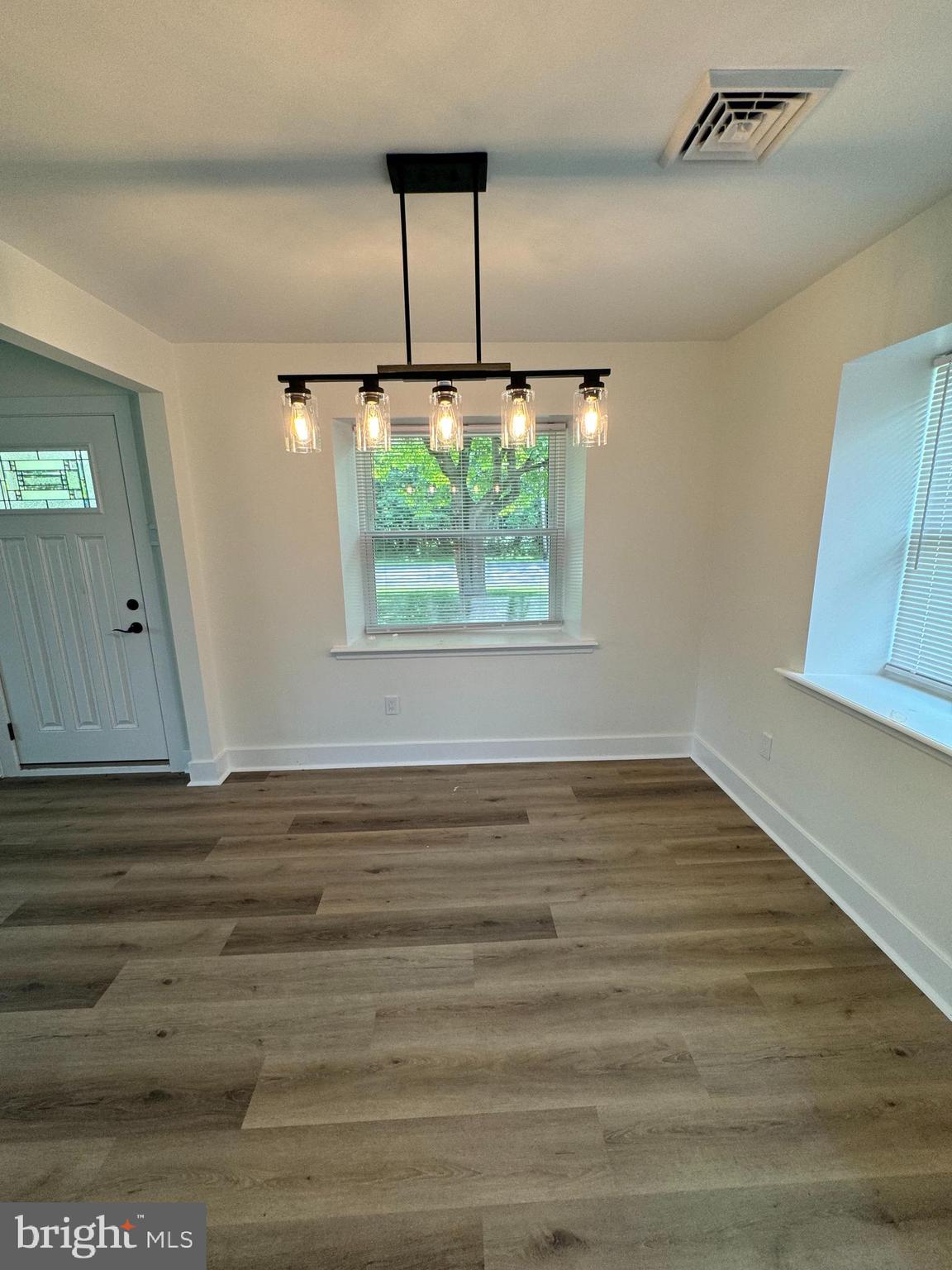 8606 Verree Road Philadelphia, PA 19115 - Photo 11 of 40 an empty room with wooden floor and windows