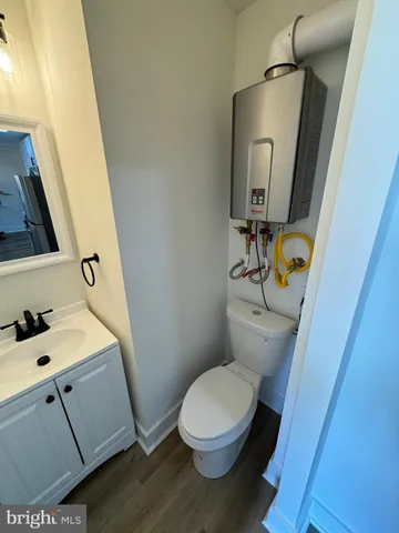 a white toilet sitting next to a bathroom sink
