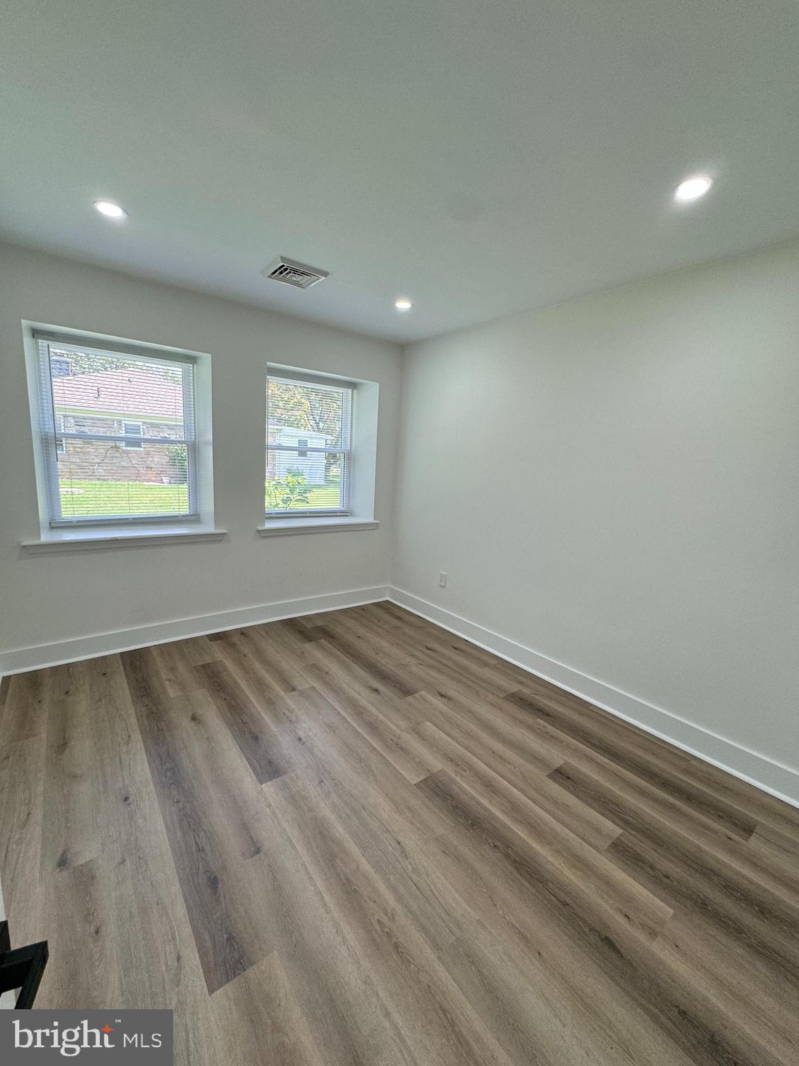 8606 Verree Road Philadelphia, PA 19115 - Photo 19 of 40 an empty room with wooden floor and windows