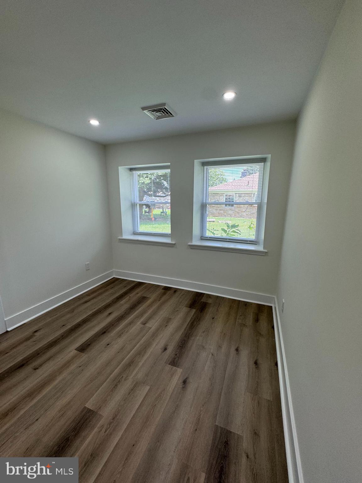 8606 Verree Road Philadelphia, PA 19115 - Photo 20 of 40 an empty room with wooden floor and windows