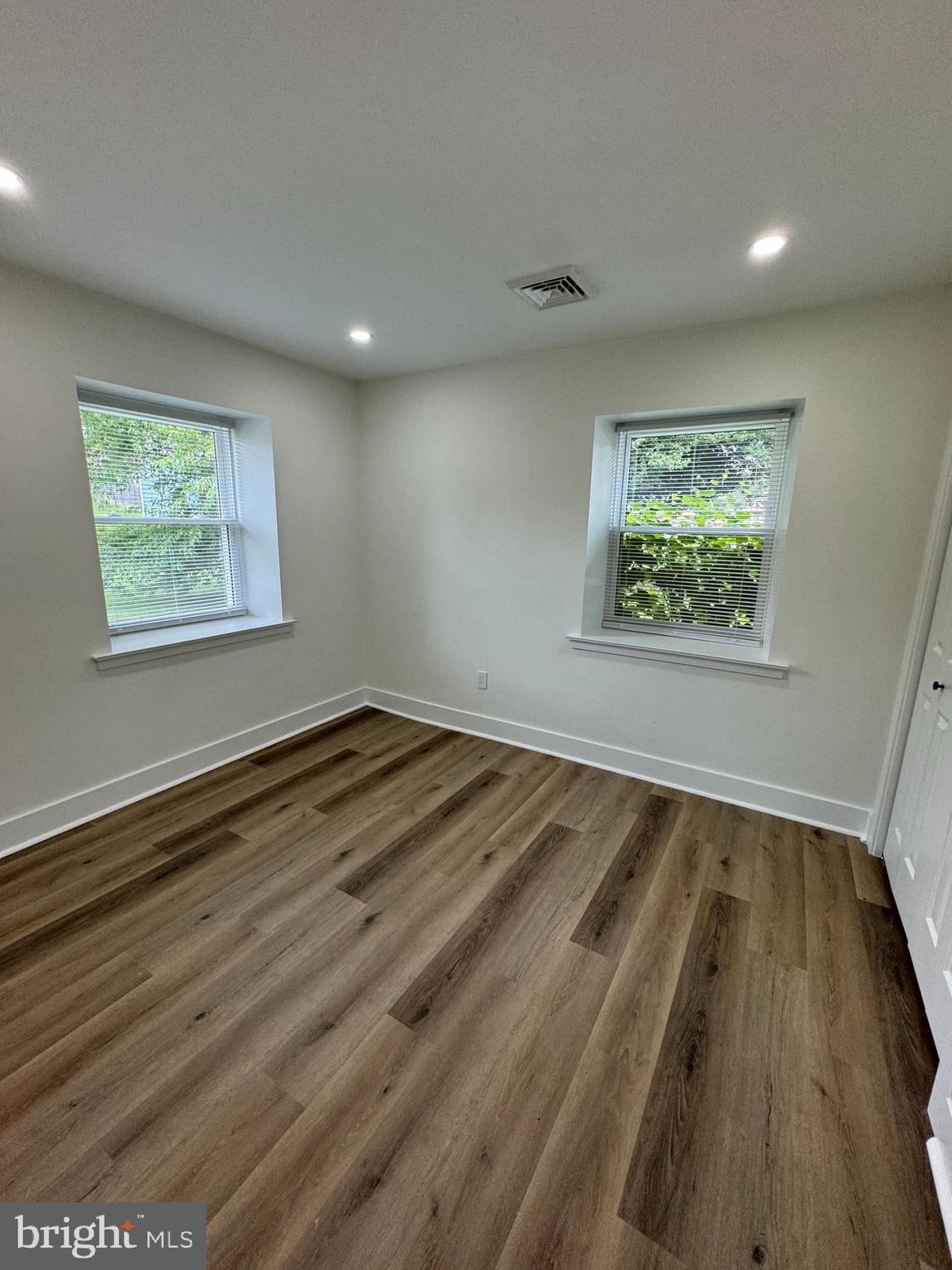8606 Verree Road Philadelphia, PA 19115 - Photo 26 of 40 an empty room with wooden floor and windows
