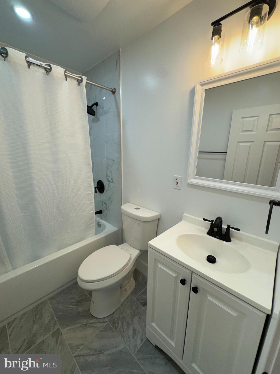 8606 Verree Road Philadelphia, PA 19115 - Photo 32 of 40 a bathroom with a sink a toilet and shower