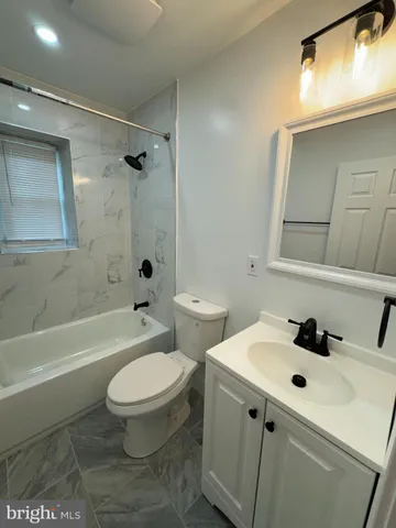 a bathroom with a sink a toilet and a bathtub