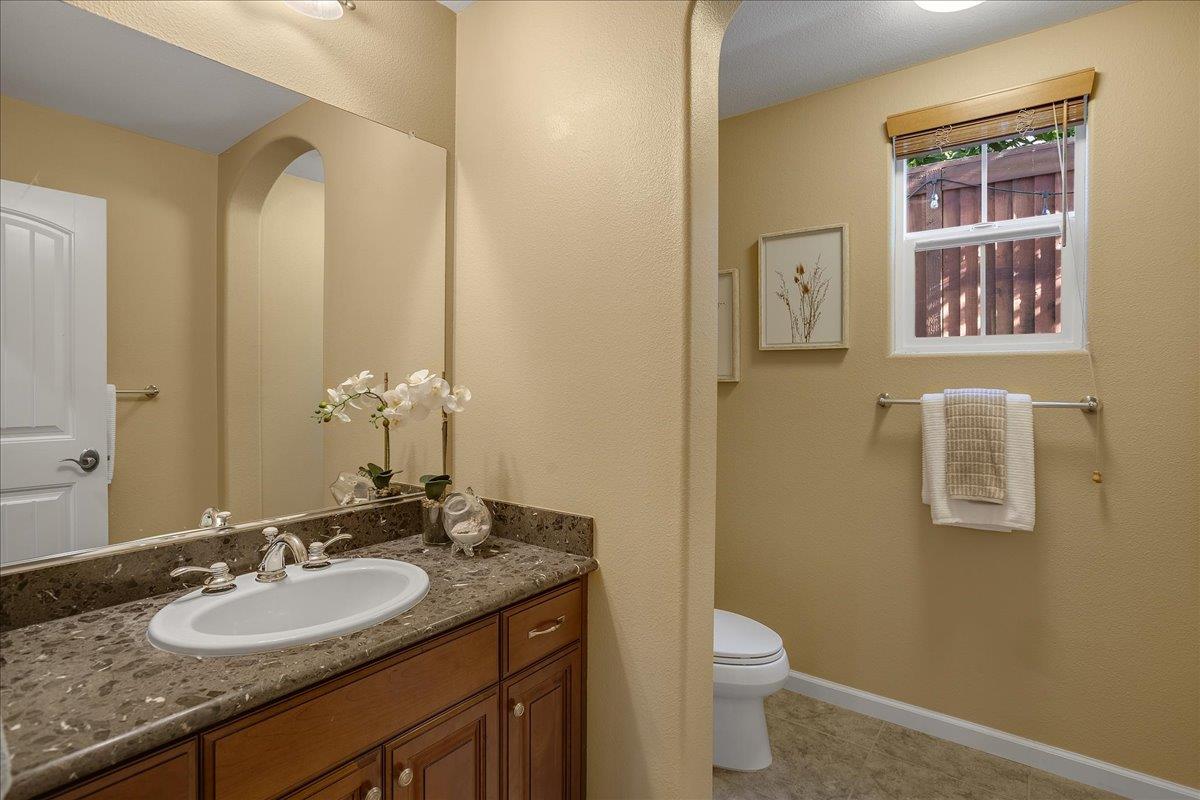 7626 Braid Court Gilroy, CA 95020 - Photo 16 of 49 a bathroom with a granite countertop sink toilet and mirror