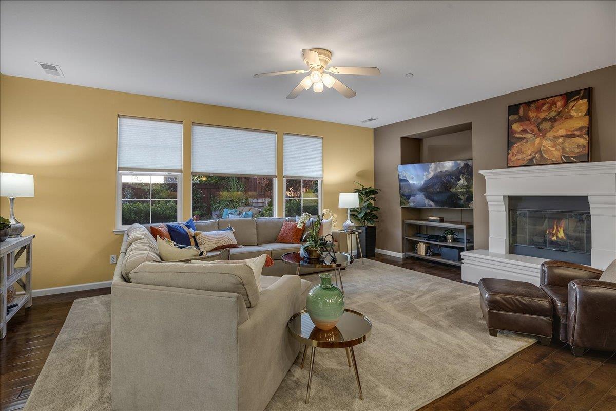 7626 Braid Court Gilroy, CA 95020 - Photo 20 of 49 a living room with furniture a fireplace and a flat screen tv