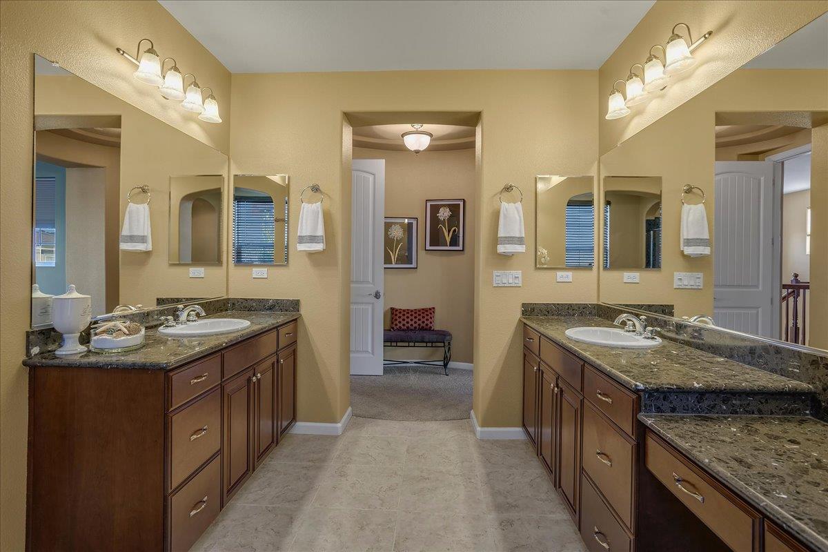 7626 Braid Court Gilroy, CA 95020 - Photo 31 of 49 a spacious bathroom with a granite countertop double vanity sink and a mirror