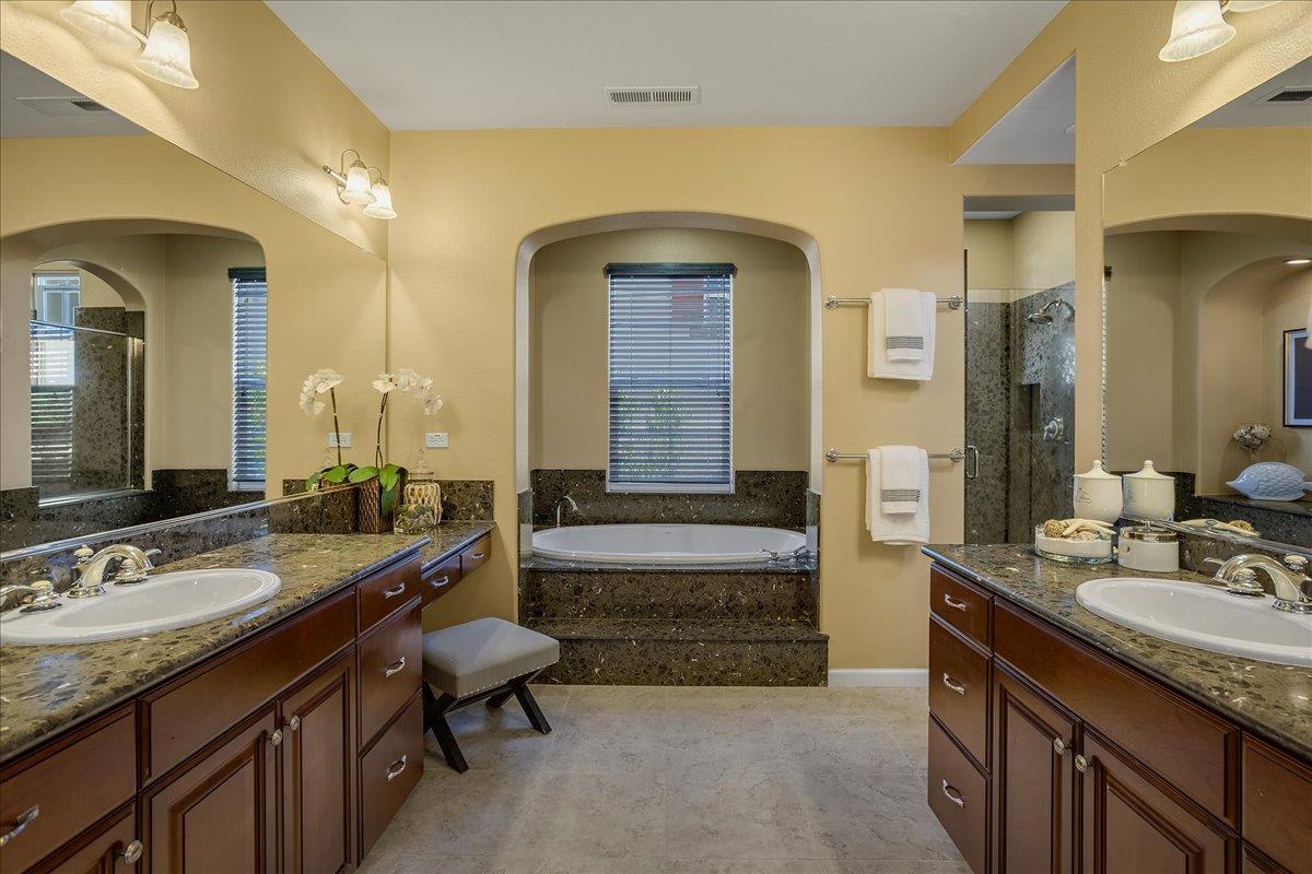 7626 Braid Court Gilroy, CA 95020 - Photo 32 of 49 a en suite bathroom with a granite countertop tub double vanity and a sink