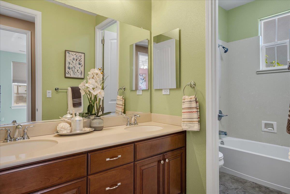 7626 Braid Court Gilroy, CA 95020 - Photo 36 of 49 a bathroom with a granite countertop sink and a mirror