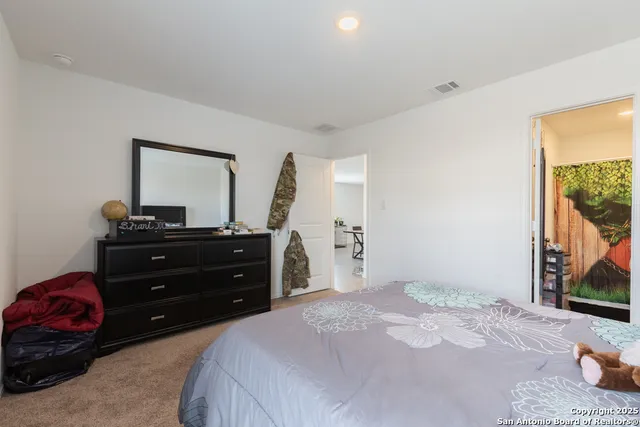 a bedroom with a bed and a dresser