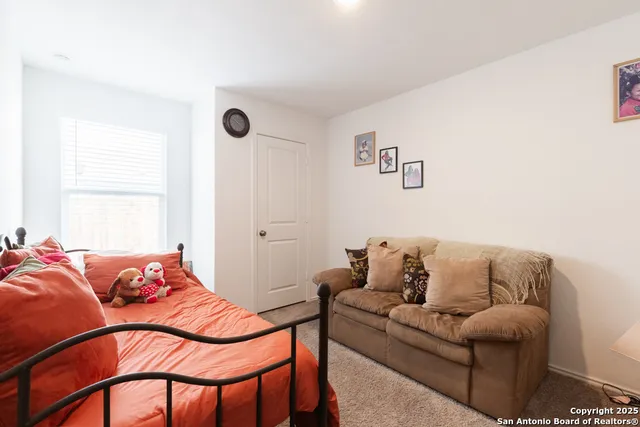 a living room with blue couches and a potted plant