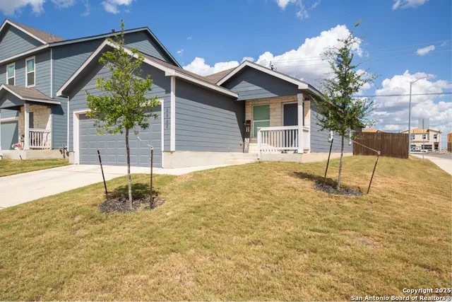 a backyard of a house with table and chairs
