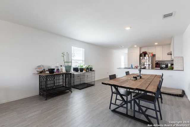 a view of a dining room with furniture and wooden floor