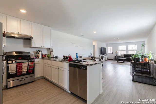 a kitchen with sink cabinets and wooden floor