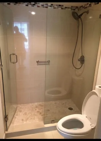 a bathroom with a toilet and shower