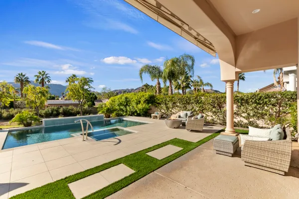 a view of a patio with couches and potted plants