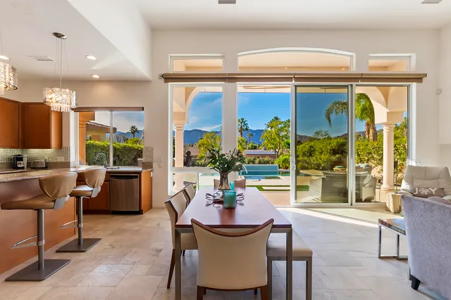 a dining room with furniture a fireplace and a large window