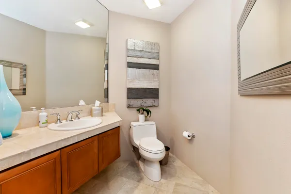a bathroom with a toilet a sink and mirror