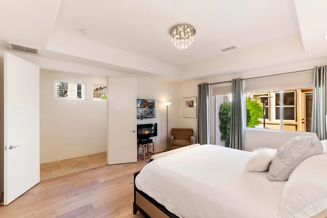 a bedroom with a bed and a large window