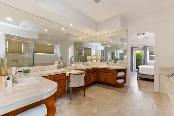 a large bathroom with a large tub and sink