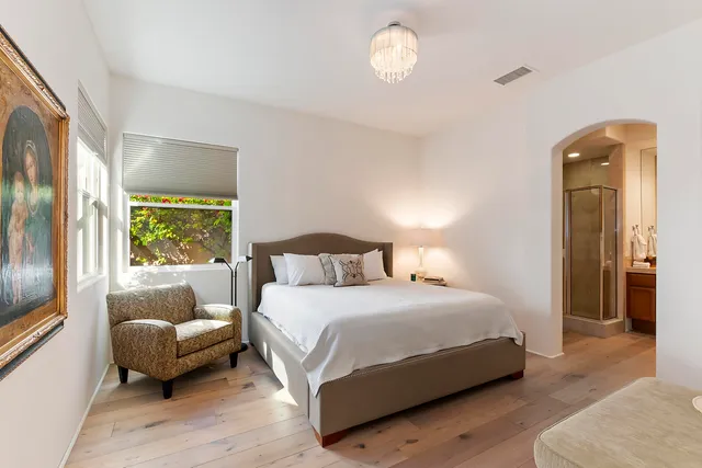 a bedroom with a bed and a couch