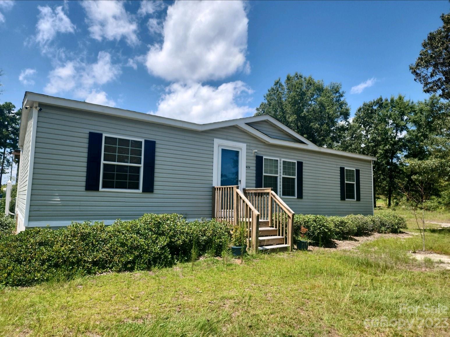 626 Union School Road McBee, SC 29101 - Photo 1 of 19 a view of a house with backyard and garden