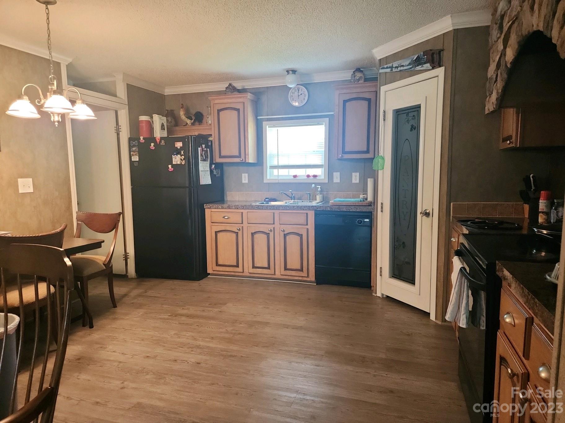 626 Union School Road McBee, SC 29101 - Photo 12 of 19 a kitchen with stainless steel appliances granite countertop a refrigerator a stove top oven a sink dishwasher and wooden cabinets