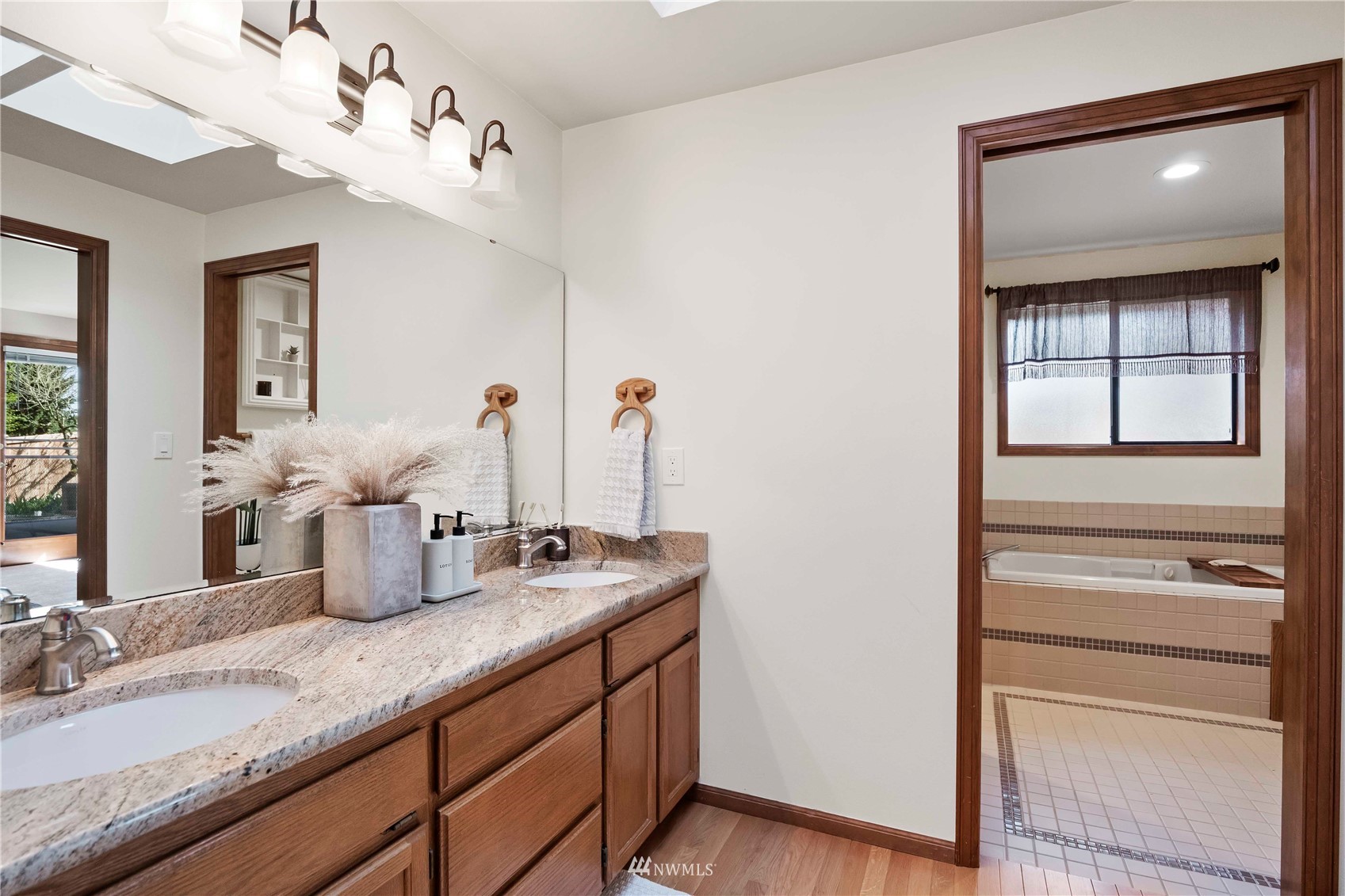 23906 23rd Drive Southeast Bothell, WA 98021 - Photo 16 of 25 a bathroom with a double vanity sink and a mirror