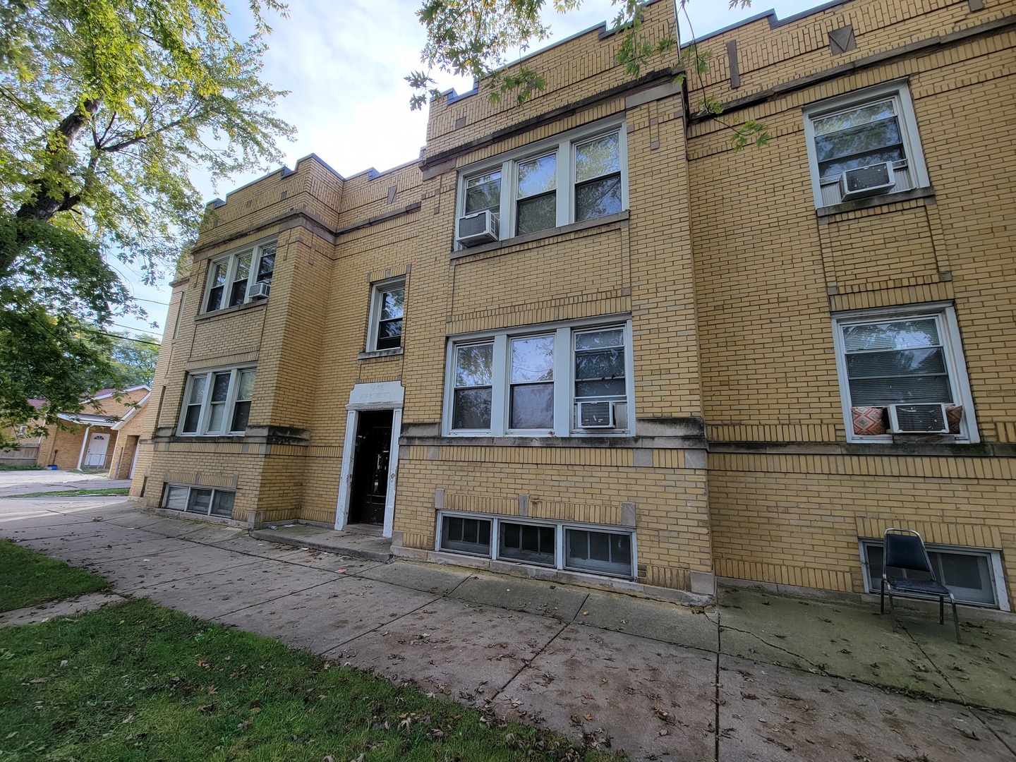 a view of a brick building next to a yard