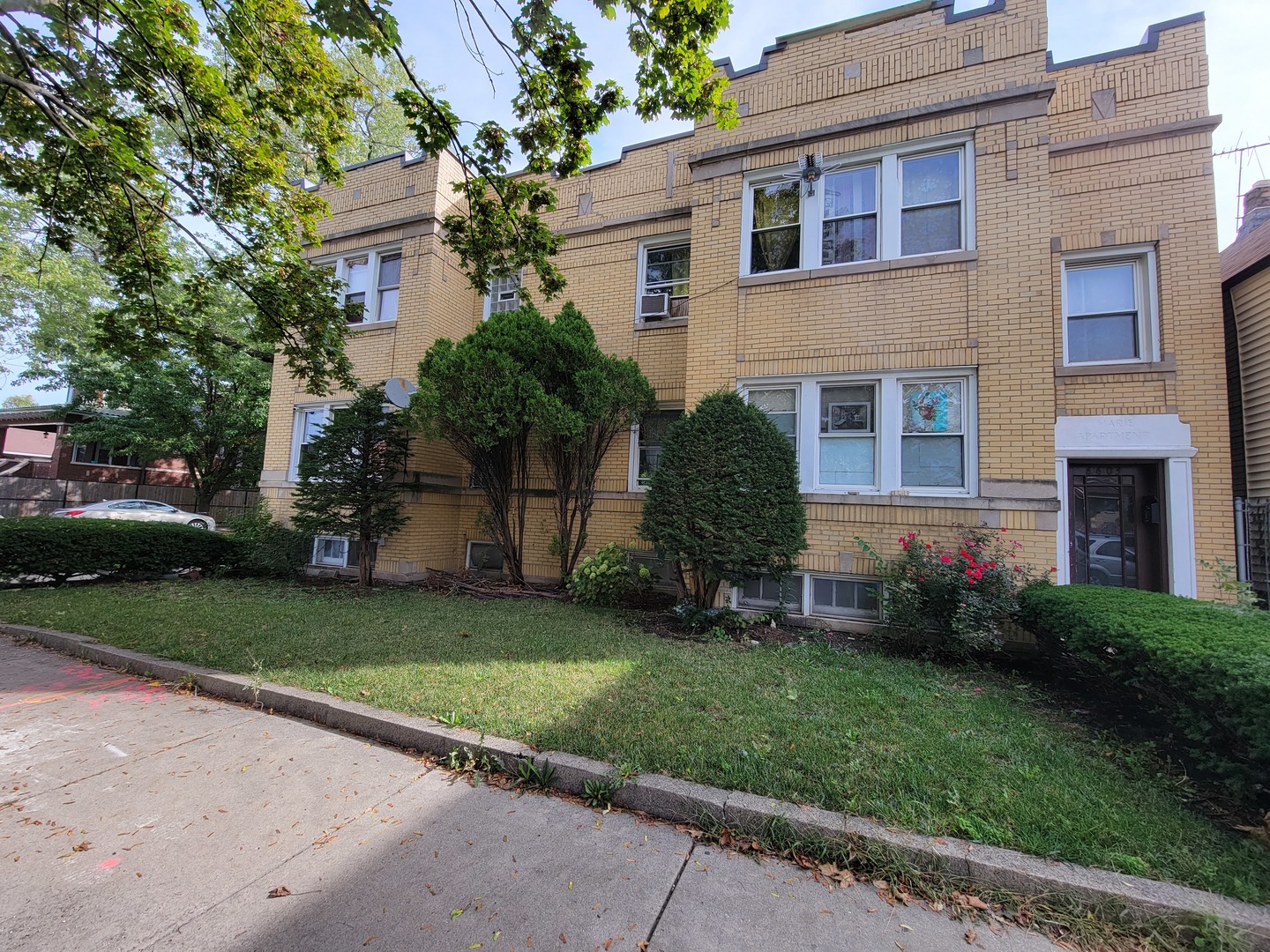 6601 South Troy Street Chicago, IL 60629 - Photo 3 of 5 a front view of a house with a garden and yard