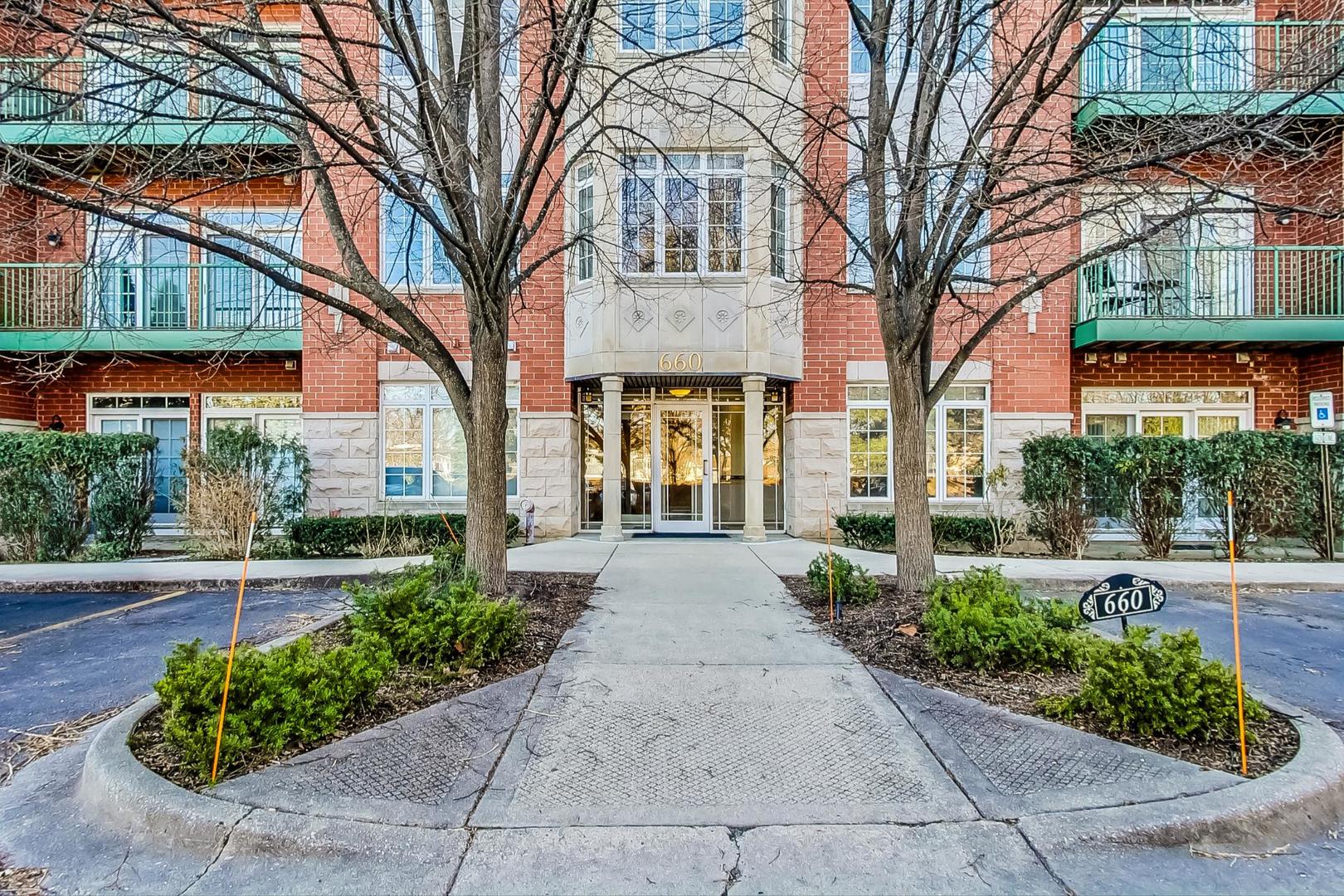 660 McHenry Road, Unit 1102 Wheeling, IL 60090 - Photo 2 of 19 a front view of a house with garden
