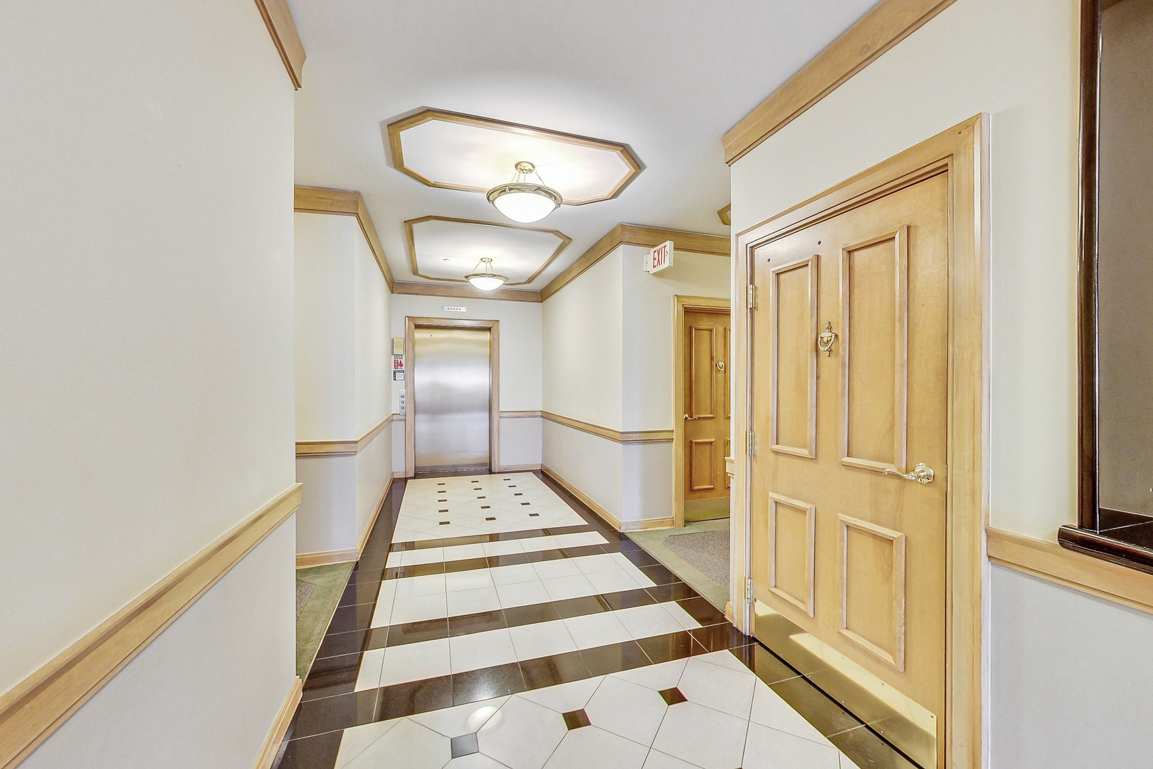 660 McHenry Road, Unit 1102 Wheeling, IL 60090 - Photo 4 of 19 a view of a hallway with wooden floor and staircase
