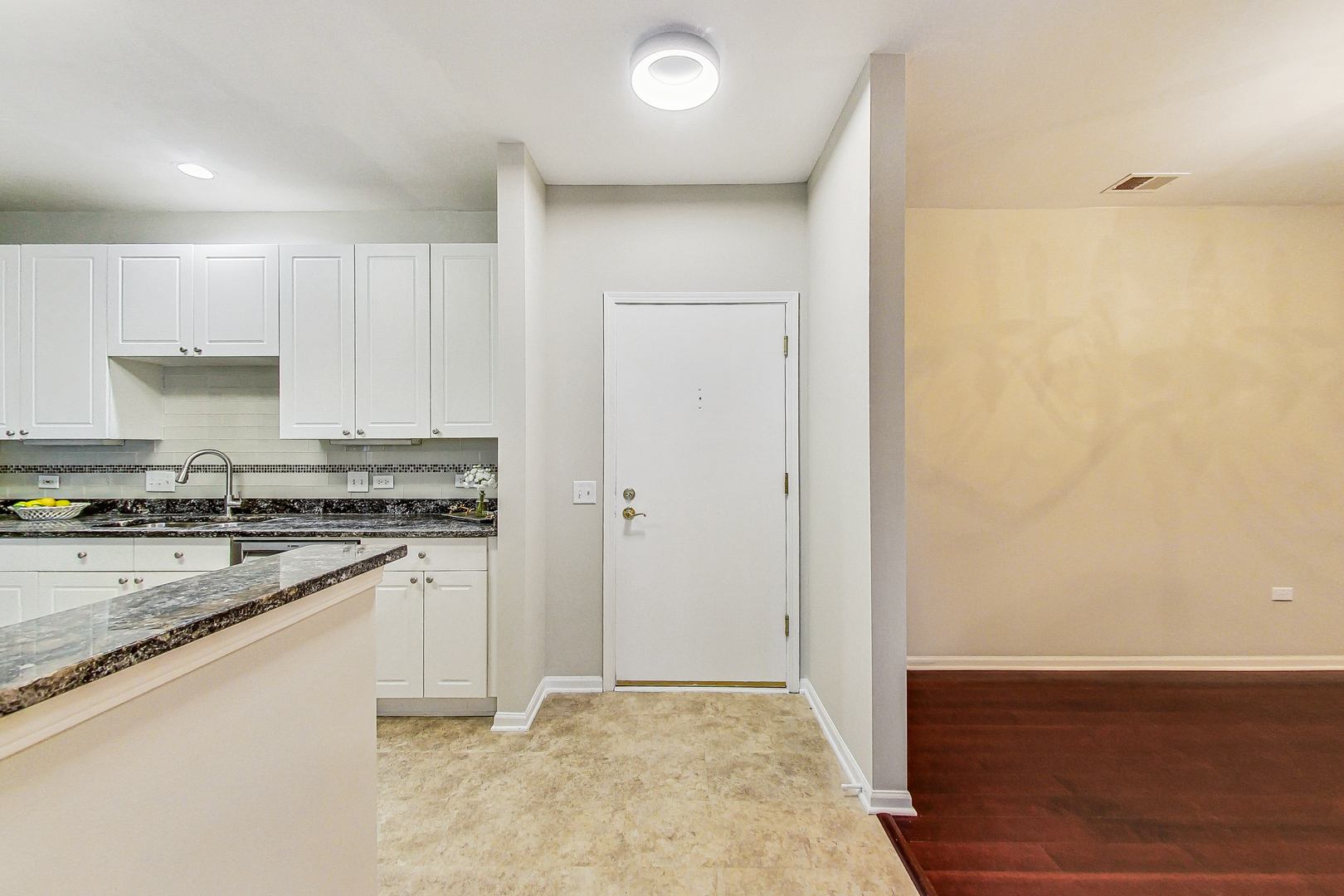 660 McHenry Road, Unit 1102 Wheeling, IL 60090 - Photo 8 of 19 a kitchen with granite countertop a sink and a stove