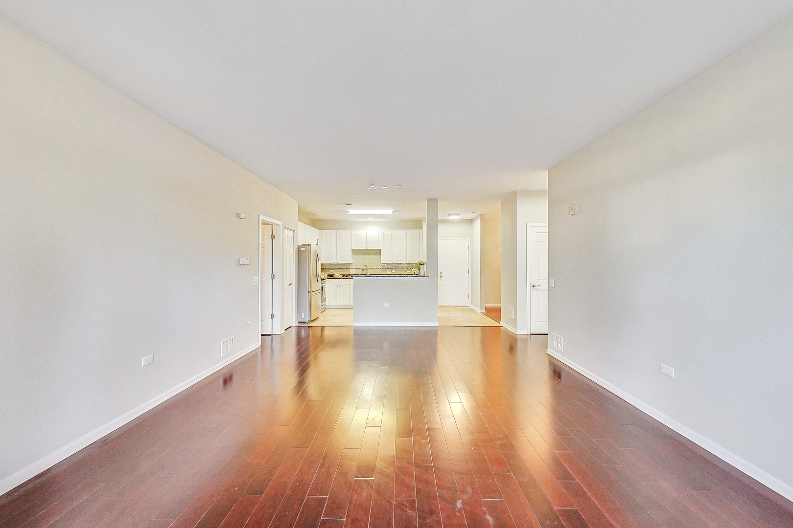 660 McHenry Road, Unit 1102 Wheeling, IL 60090 - Photo 10 of 19 a view of an empty room with wooden floor